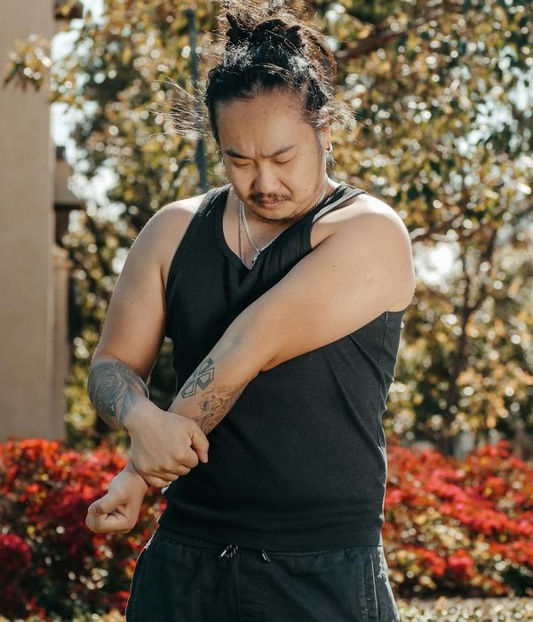Man stretching outdoors at sunrise feeling energized and focused.